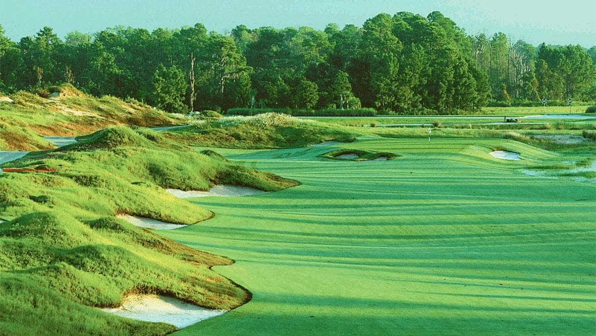 ChampionsGate National course fairway with bunkers, dunes, water, and tree line.